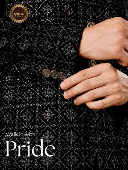 Walk in with pride. A detailed view of a black textured sherwani, focusing on the fabric's pattern and the quality of the sleeve buttons.