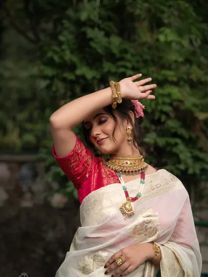 A portrait from a styled shoot for a traditional gold jewelry brand, capturing a moment of graceful movement.