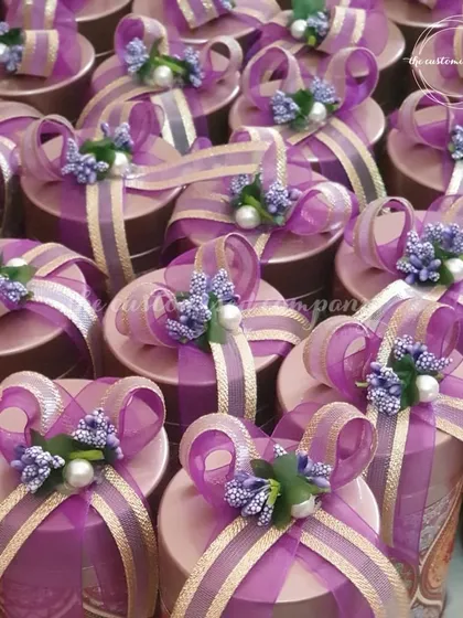 Baraat Swagat favors that make a statement. These beautifully decorated gift boxes in vibrant purple are perfect for welcoming your guests with style and warmth.