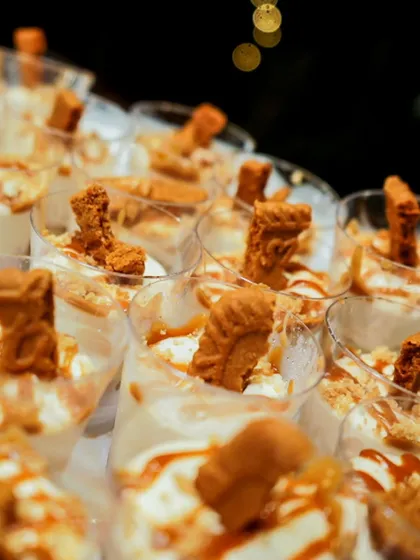 A close-up of our Biscoff cheesecake dessert cups, a modern and trendy addition to our wedding menus.