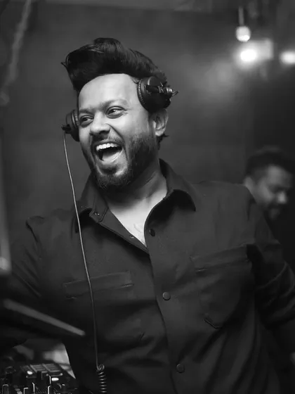 A candid laugh behind the decks. This is what pure happiness looks like.