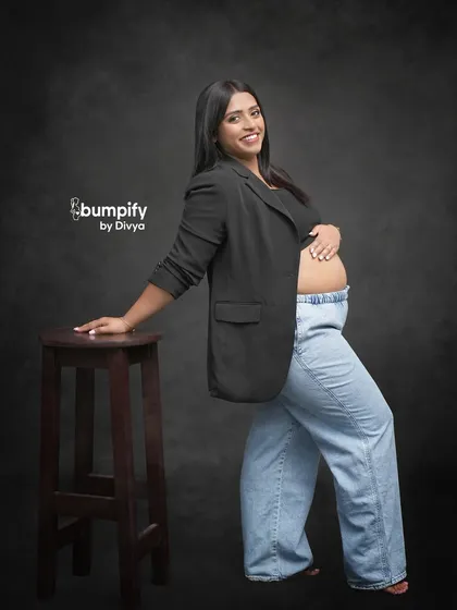 A confident and modern maternity portrait. The mom-to-be's choice of a blazer and jeans shows that you can bring your own personal style to the shoot.