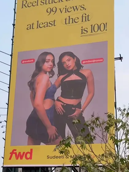 The corresponding billboard for the denim look, showcasing how the subtle makeup enhances the models' features without distracting from the fashion.