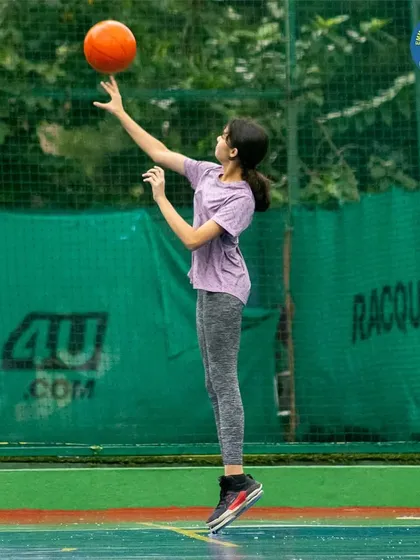 A young girl masters the art of spinning a basketball on her finger. While having fun, we build skills and a deep connection with the game.