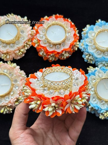 These floral T-light holders in bright orange, peach, and blue are perfect for adding a pop of color to your decor.