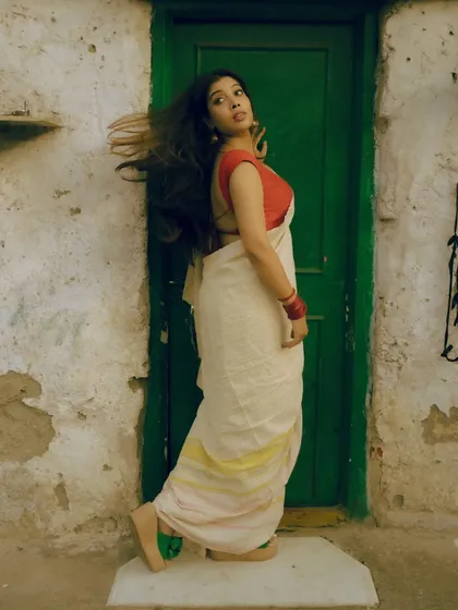 A series from an outdoor shoot, using a rustic green door as a complementary background for the red and white saree. These images show how I use color theory and natural environments to compose a shot.