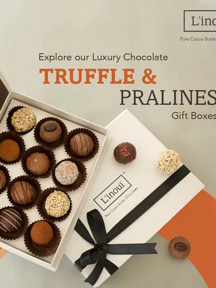 Our luxury truffle and praline gift box, opened to reveal an assortment of handcrafted chocolates. This is our most popular gift, perfect for celebrating anniversaries, promotions, or simply showing appreciation with a truly decadent treat.