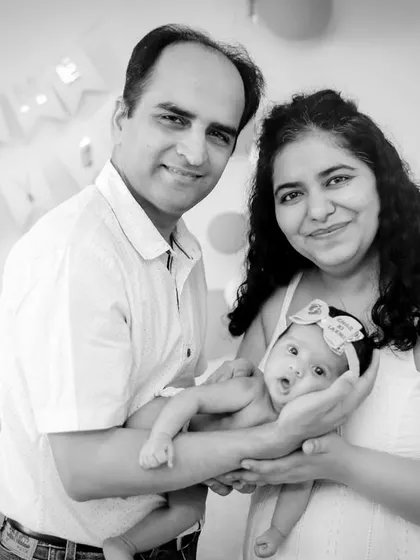 A happy family portrait with a newborn, converted to black and white to create a timeless family heirloom.