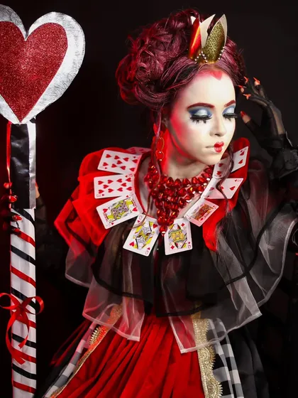 A full-length view of the "Queen of Hearts" character. This look involved creating a custom collar from playing cards and a dramatic, theatrical makeup style.