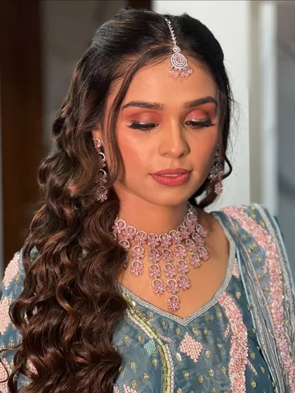 A close-up of the soft, peachy-pink eyeshadow and flawless skin.