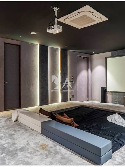 This angle shows the large projector screen and the discreetly integrated speakers. The multi-level seating platform ensures that every viewer has an unobstructed line of sight.