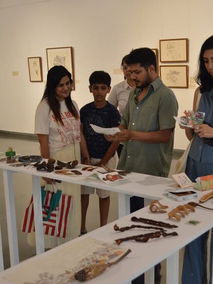 A family explores the interactive table display at Mohit Mahato's solo show.