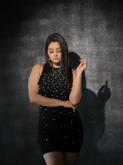 A pensive, downward-looking pose that conveys a sense of introspection.