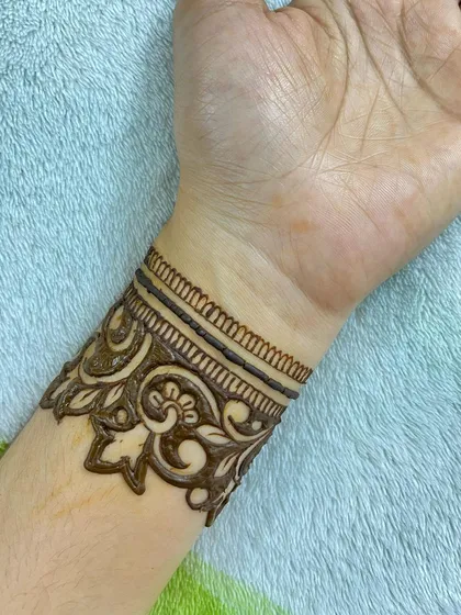 A close up of the dark, patterned wrist cuff.