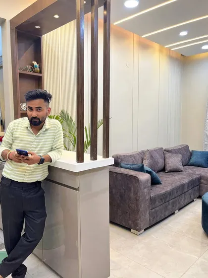 Here I am at the completed Gurgaon project, standing by the custom partition and breakfast counter we built.