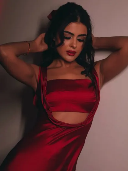 This shot captures the texture of the satin dress and the flawless finish of the makeup.