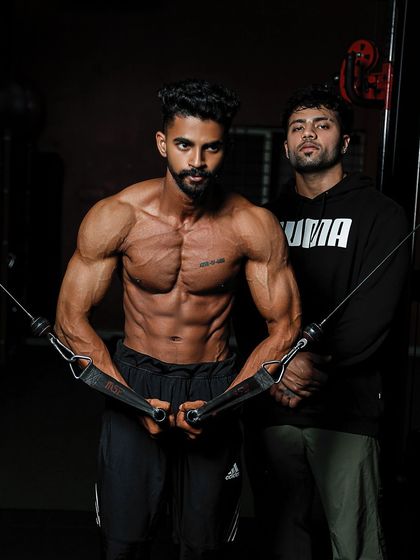 Another shot with my client, highlighting the results of his contest prep. His physique is sharp, full, and ready for the stage.