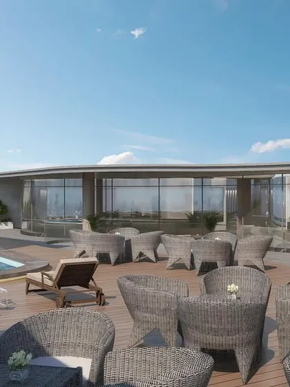 The rooftop amenity space of a wave-inspired office building. The design includes a pool and lounge area, creating a space where employees can relax, socialize, and find inspiration.
