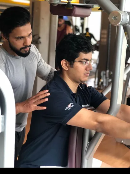 Form is everything. Here, I am providing hands-on guidance to a client during a chest press exercise. I ensure every repetition is performed with perfect technique to maximize results and prevent injury, whether you are a beginner or an experienced lifter.