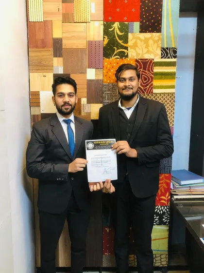 An intern proudly receives his certificate of completion in our office. This formal acknowledgment is an important asset for their resume and future legal career.