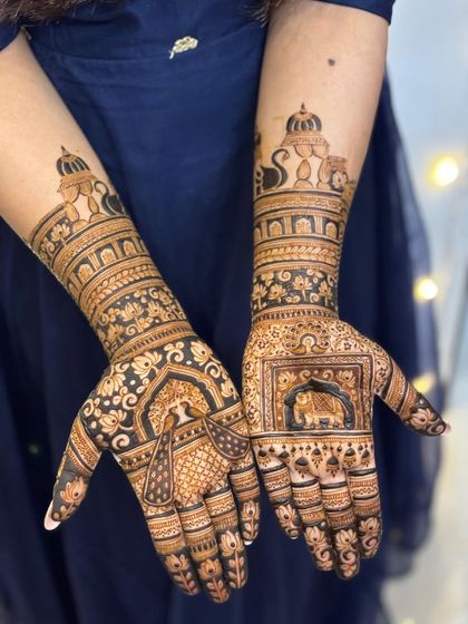 A close-up of the bride's hands, featuring beautiful animal motifs like elephants and peacocks.