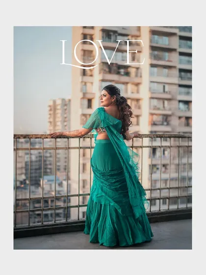 A modern bridal portrait with an urban backdrop. The bride's pose and the cityscape create a contemporary and stylish feel.