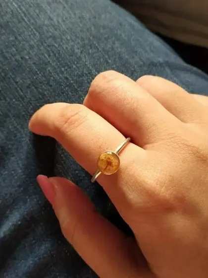 This simple and elegant ring features a preserved 'touch-me-not' flower on a thin silver-toned band. It's a perfect example of how even the smallest flower can be turned into a beautiful piece of jewelry.