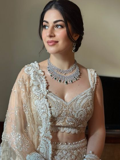 A close-up of Oezlem's soft and angelic sangeet makeup. The focus is on her bright, defined eyes and the flawless, dewy finish of her skin.