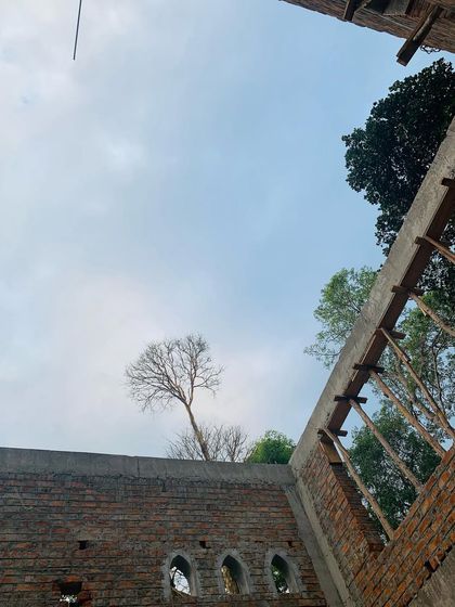 The sky seen from our third Coorg home during its construction. Even in its skeletal form, the structure is designed to frame the nature around it, capturing views of the sky and the surrounding forest trees.
