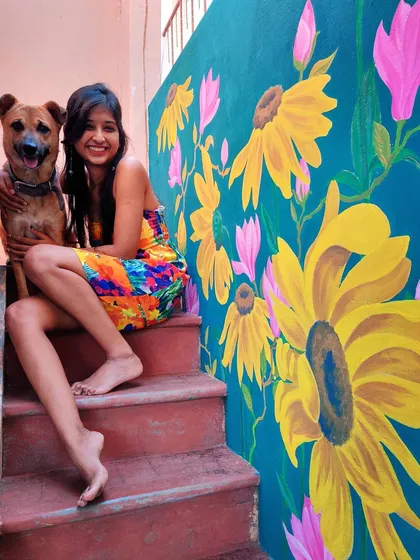 A splash of sunshine for a home staircase. This vibrant sunflower mural was designed to bring joy and energy into the space. It’s a perfect example of how I use bright, happy colors to completely transform a part of your home. And yes, that’s my furry assistant approving of the final work.