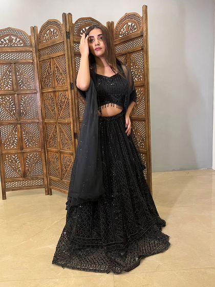 A full-length shot of the black lehenga, perfect for a sangeet or reception. It's a versatile and glamorous addition to your wardrobe, bought smartly.