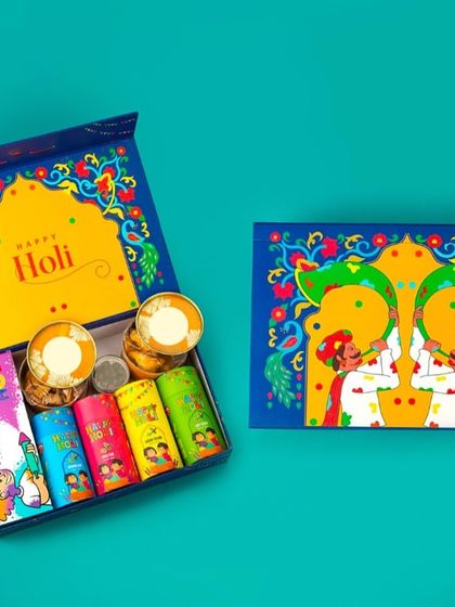 This vibrant blue Holi hamper is packed with fun. It includes five tubes of colorful gulal and two containers of silver coins, adding a unique touch to your celebration.