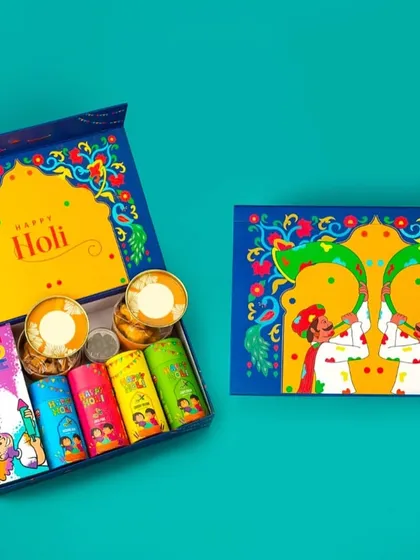 This vibrant blue Holi hamper is packed with fun. It includes five tubes of colorful gulal and two containers of silver coins, adding a unique touch to your celebration.