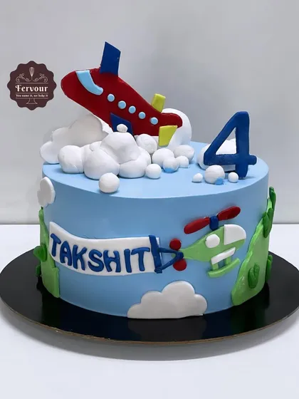 Let's fly high! An aeroplane theme cake for a 4th birthday. This vanilla truffle cake is decorated with a fondant plane, helicopter, and clouds.