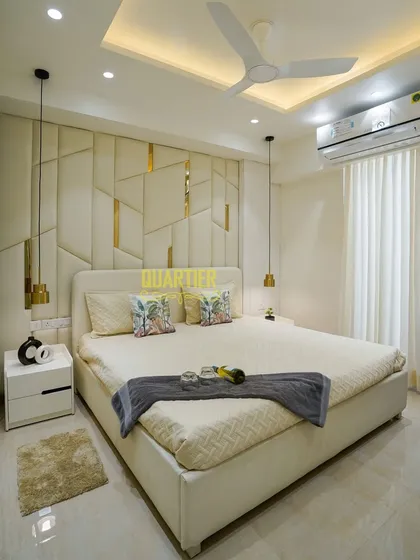 I believe a master bedroom should be a personal retreat. For this home in Tata LaVida, Gurugram, I designed a custom upholstered headboard with geometric patterns and gold inlays, complemented by soft pendant lighting to create a serene and luxurious atmosphere for rest and relaxation.