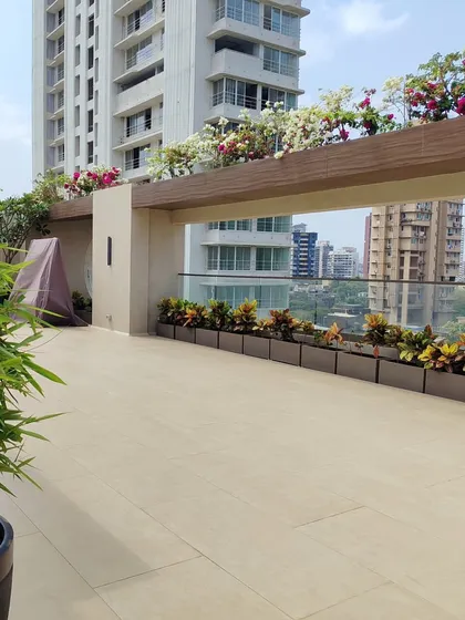 This image shows the clean lines and modern aesthetic of the terrace, with planters lining the glass railing.