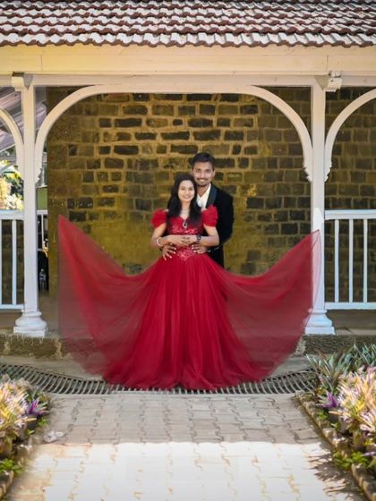 A fairytale pose with a gown to match. The butterfly sleeves and full skirt of this red gown add a whimsical touch to this pre-wedding picture.