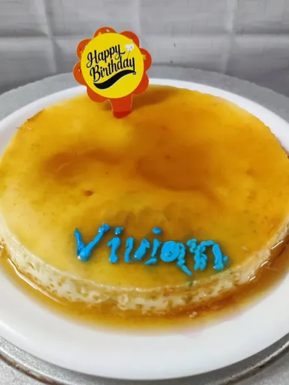 My creamy caramel custard is a simple, no-bake dessert that I can personalize for you. This one was for a birthday, with the name "Vivian" written in blue icing.
