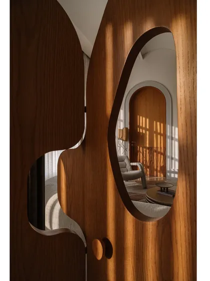 Our 'Hide N Seek' screen is furniture that invites play. Designed to divide a large suite into a salon and bedroom, its amoebic wooden panels have organic cutouts that frame views and create intriguing vignettes. It’s a sculptural piece that is both a space divider and an interactive art form.