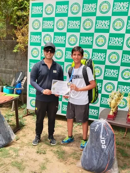 Another one of my dedicated players, Ansh, receiving his certificate and medal for placing 3rd in the All India Tennis Tournament. His commitment during training really showed.