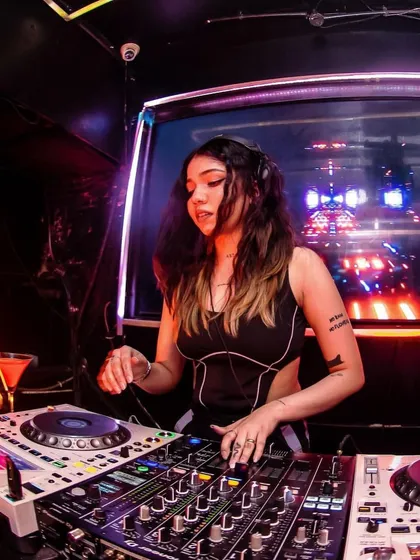 Adjusting the levels to get the perfect sound. Technical skill is just as important as track selection for a professional DJ set.