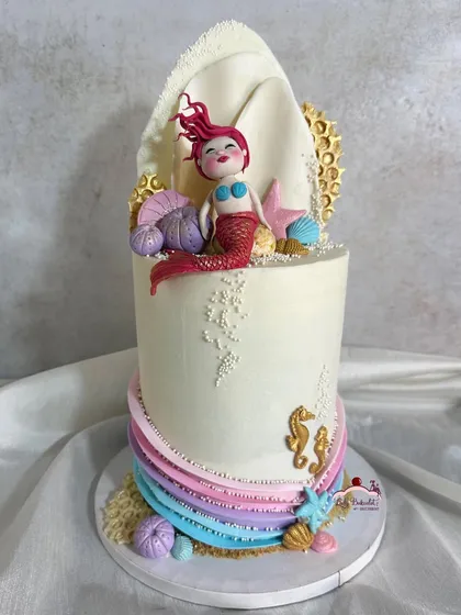 Another angle of this artistic mermaid cake, showing the colorful ruffled buttercream waves.