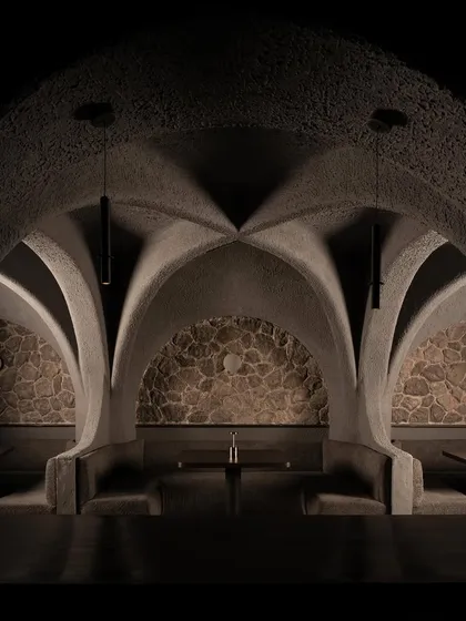 A symmetrical composition of the dining pods. The raw stone backdrops contrast with the smooth, sculpted concrete, creating a rich tactility and a visual anchor for each seating area.