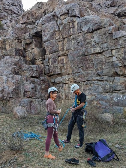 Safety first, always. We ensure everyone is comfortable with their gear, like these climbers preparing for a route with helmets and harnesses at the ready.