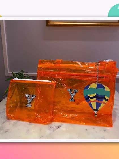 An orange version of our jelly tote bag and pouch set, personalised with the initial 'Y' and a hot air balloon charm.