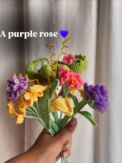 Adding a purple rose to the Rapunzel bouquet, diversifying the types of flowers in the arrangement.