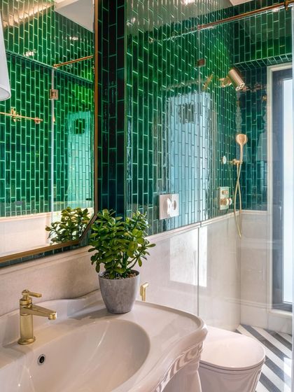 Can you feel the gentle caress of emerald hues and vintage whispers? In this powder room, I paired classic green subway tiles with a vintage-style sink and gold fixtures to create a sanctuary where past meets present.