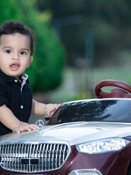 A confident little driver posing with his stylish convertible.