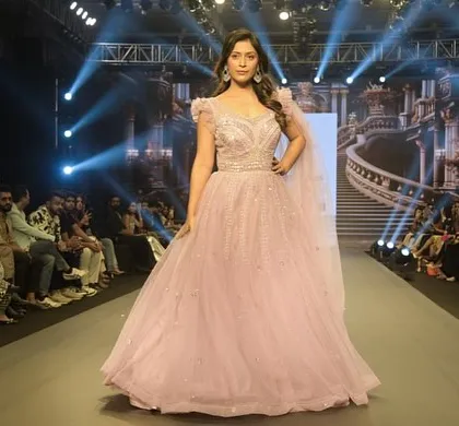 Another stunning shot of the Muave Pink gown. The way it catches the light on the runway is just magical. You can get this dream gown for your special day.