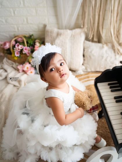 Those big, curious eyes looking right at the camera. This beautiful portrait from a sitter session captures the sweet and gentle nature of this little girl.